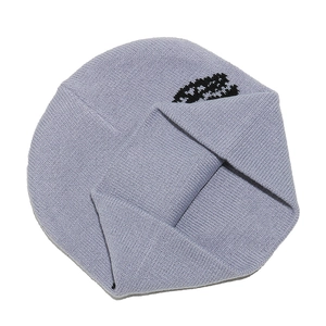 Detailed view of light purple knitted beanie for boys with black dinosaur jacquard pattern