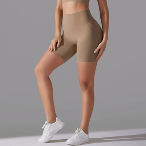 Detail of high-waist seamless yoga shorts in matte khaki showing compression fit