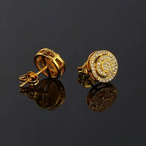 Hip hop style gold round stud earrings with pave set zircons on black mirror surface