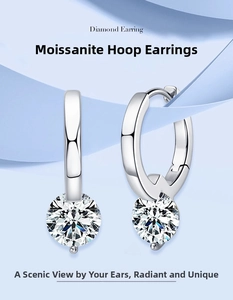 Close-up of elegant moissanite hoop earrings in 925 sterling silver with round stones