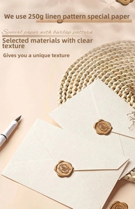 Detail of 250g linen-textured envelope with a gold Thank You wax seal and vintage pen