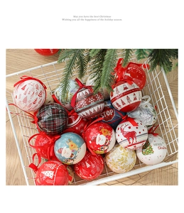 Close-up of festive Christmas baubles with reindeer and snowflake patterns in a wire basket
