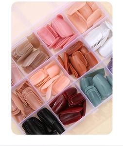 Detailed view of 12-color glossy coffin press-on nails set in clear storage box