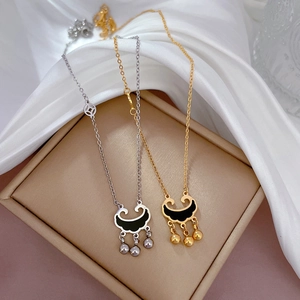 Titanium steel concentric lock pendant necklaces in gold and silver on silk background