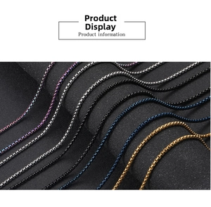Macro shot of colorful stainless steel box chains in silver, black, blue and gold finishes