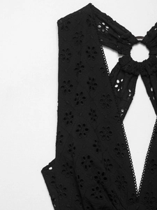 Detail of black hollow out embroidery fabric with ring connector for summer dress