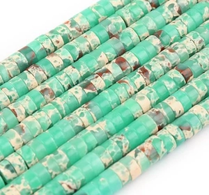 Macro detail of disc-shaped green emperor pine stone spacer beads for jewelry making