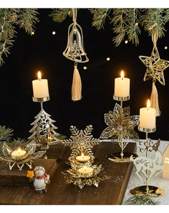 Détail du photophore doré en métal évidé avec motifs de Noël sur une table festive