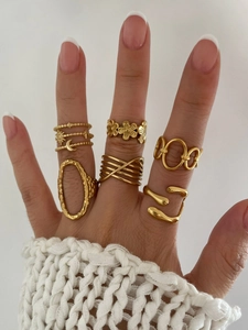 Detailed view of 18K gold plated titanium ring set with celestial and floral patterns
