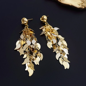 Exaggerated gold leaf tassel earrings with layered sequins and elegant fringe design