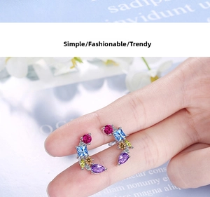 Detailed close-up of colorful zircon stud earrings featuring vibrant multi-shape gemstones