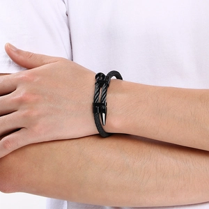 Close-up detail of black punk braided leather bracelet with stainless steel nail head