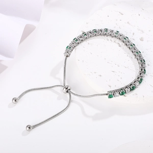 Detail of silver tennis bracelet with green and white zircons and adjustable sliding clasp