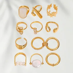 Luxury 11-piece gold ring set with zircon and pearl accents on elegant fabric