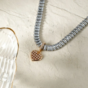 Elegant French style gold heart pendant necklace with shimmering zircon stones on bone chain
