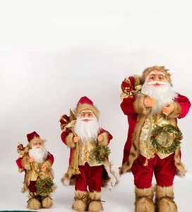 Three-piece Santa Claus figurine set featuring golden trim vests and red gift bags