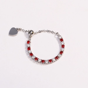 Detail of adjustable silver ring with red and white zircons and heart pendant