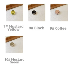 Detail of colorful mini acetate hair clips featuring cute cartoon smiley face designs