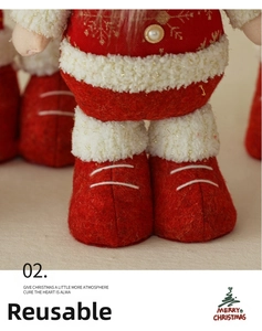Macro detail of red felt boots and gold snowflake embroidery on Christmas doll ornament