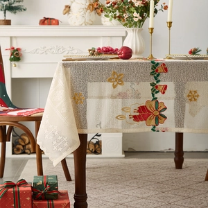 Beige lace Christmas tablecloth with festive embroidery on a wooden table setup