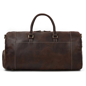 Detail view of large vintage dark brown leather duffle bag with bronze hardware buckles