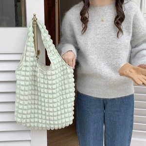 Close-up of mint green bubble texture fabric and spacious tote bag strap detail