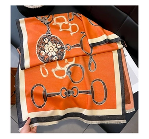 Detail of equestrian horse-bit chain patterns on premium cashmere-like long scarf with fringe