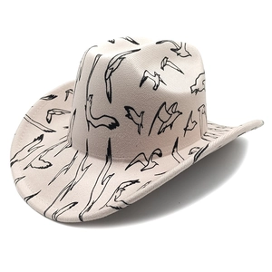 Classic beige western felt cowboy hat featuring black seagull patterns on a white background