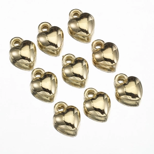 Close-up of nine polished gold heart-shaped pendants on a clean white background