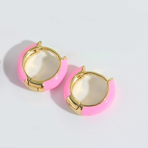 Detailed close-up of pink enamel hoop earrings with polished golden metallic finish