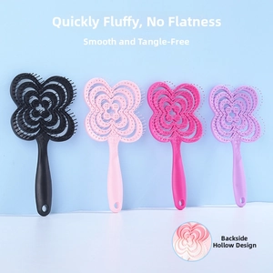 Detail of flower-shaped hollow hair brush showing ergonomic handle and back vent structure