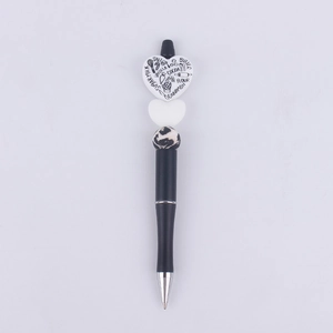 Close-up of DIY beaded pen with white heart topper featuring baking terms like sugar and milk