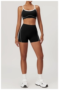 Détail des coutures blanches contrastées sur l'ensemble soutien-gorge et short de sport