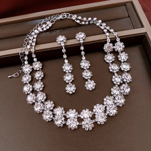 Silver flower jewelry set with rhinestones and tassel necklace in a brown box