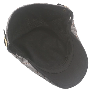 Detail view of cotton plaid beret with adjustable metal side buckle and inner lining