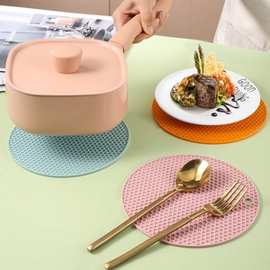 Three-piece honeycomb silicone heat resistant mats in pink blue and orange for dining tables