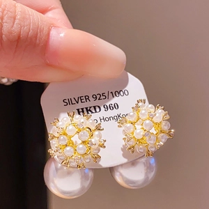 Close-up of S925 silver bow earrings with elegant pearls and sparkling crystals detail