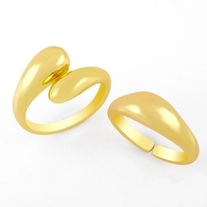 Detailed close-up of two minimalist chunky 18K gold-plated water drop open rings