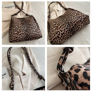 Detail view of leopard print tote bag with knotted shoulder strap and silver metal hardware