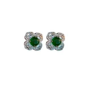 Silver flower earrings with green gemstone and zircons on a white background