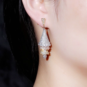Sparkling Christmas tree drop earrings with cubic zirconia shown in a side-view model shot