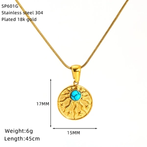 Detail of 18k gold-plated sun-star pendant with turquoise stone on stainless steel chain