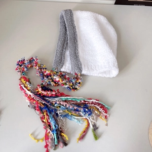 Detail of colorful long tassels and soft plush knit texture on the princess earflap hat