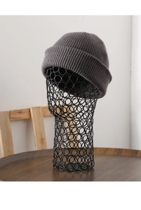 Close-up of thick dark grey ribbed knit texture on a warm winter cuffed beanie hat