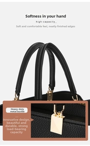 Close-up of durable golden hardware buckles and soft pebbled leather handle on a black bag