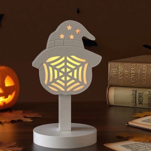 Close-up of wooden Halloween lantern with witch hat and spider web silhouette