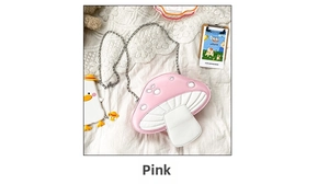 Pink mushroom-shaped crossbody bag with silver metal chain on a white fabric surface