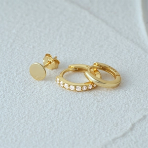 Macro shot of 925 sterling silver gold plated earrings with zircon stone details