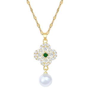 Elegant gold necklace with clover pendant, white diamonds, green gem and pearl accent