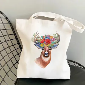 White canvas tote bag featuring artistic colorful giraffe print and floral reindeer motifs